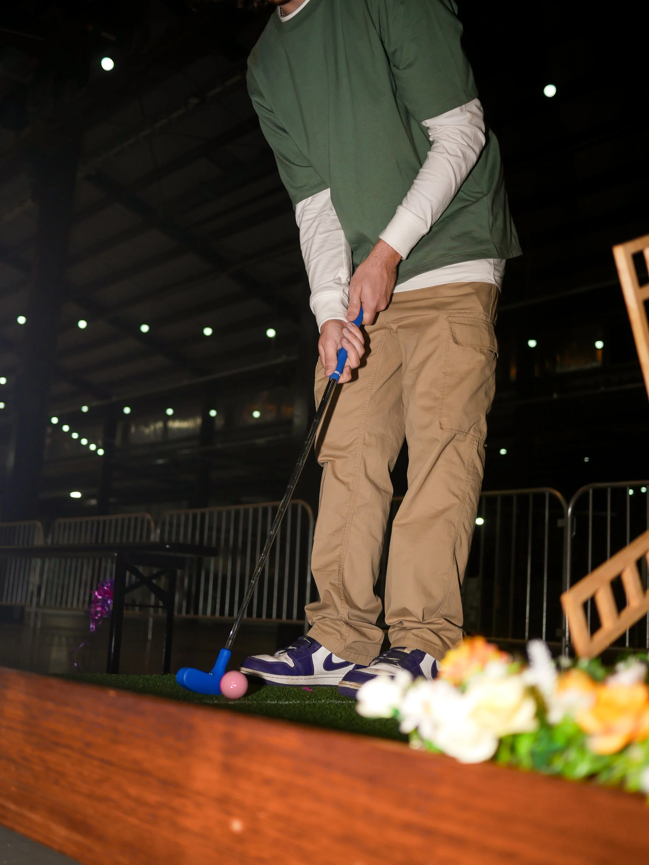 Large crowd engaged with mini-golf activation at corporate event