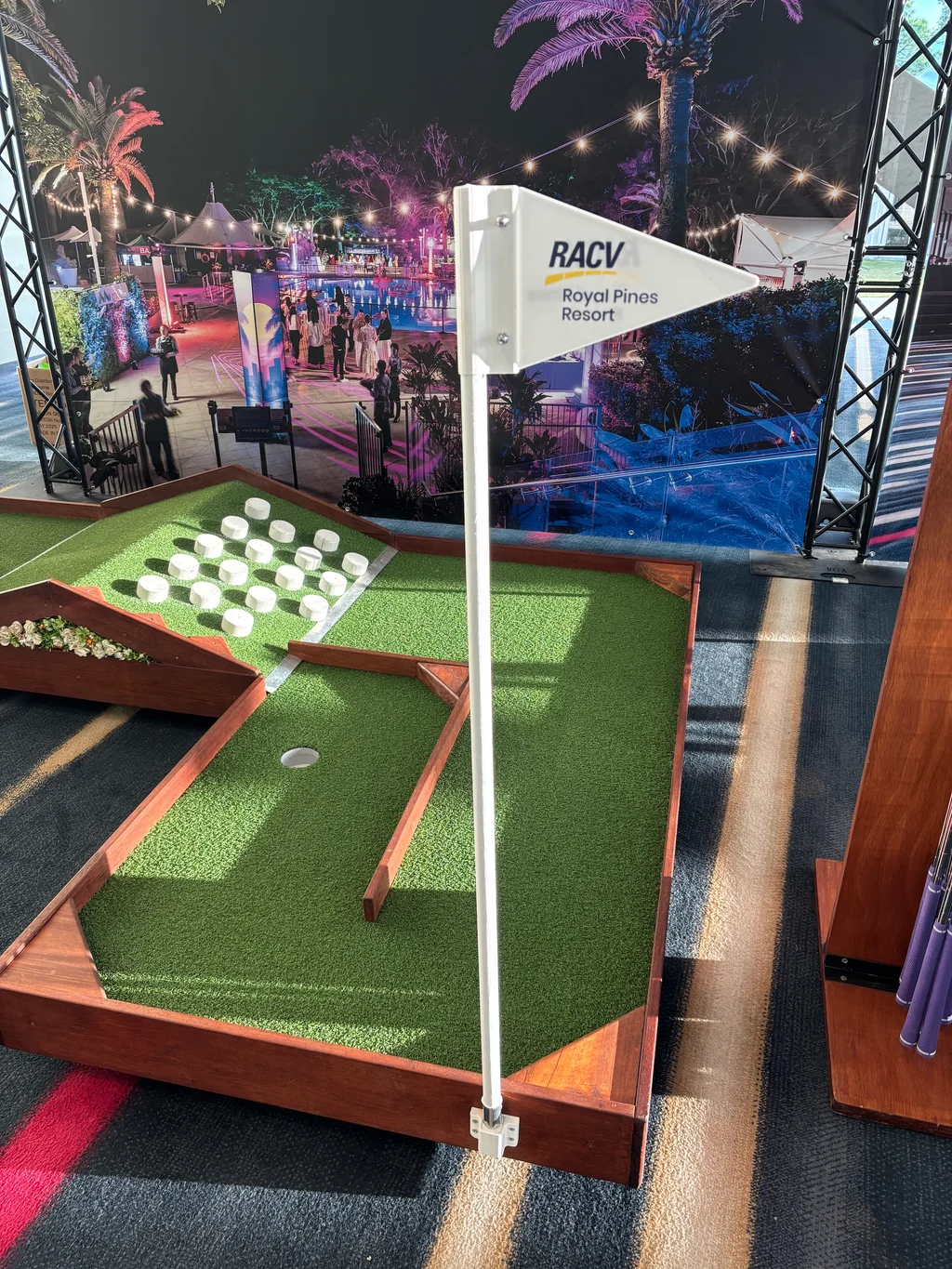 Professional mini-golf activation setup at trade show with branded elements