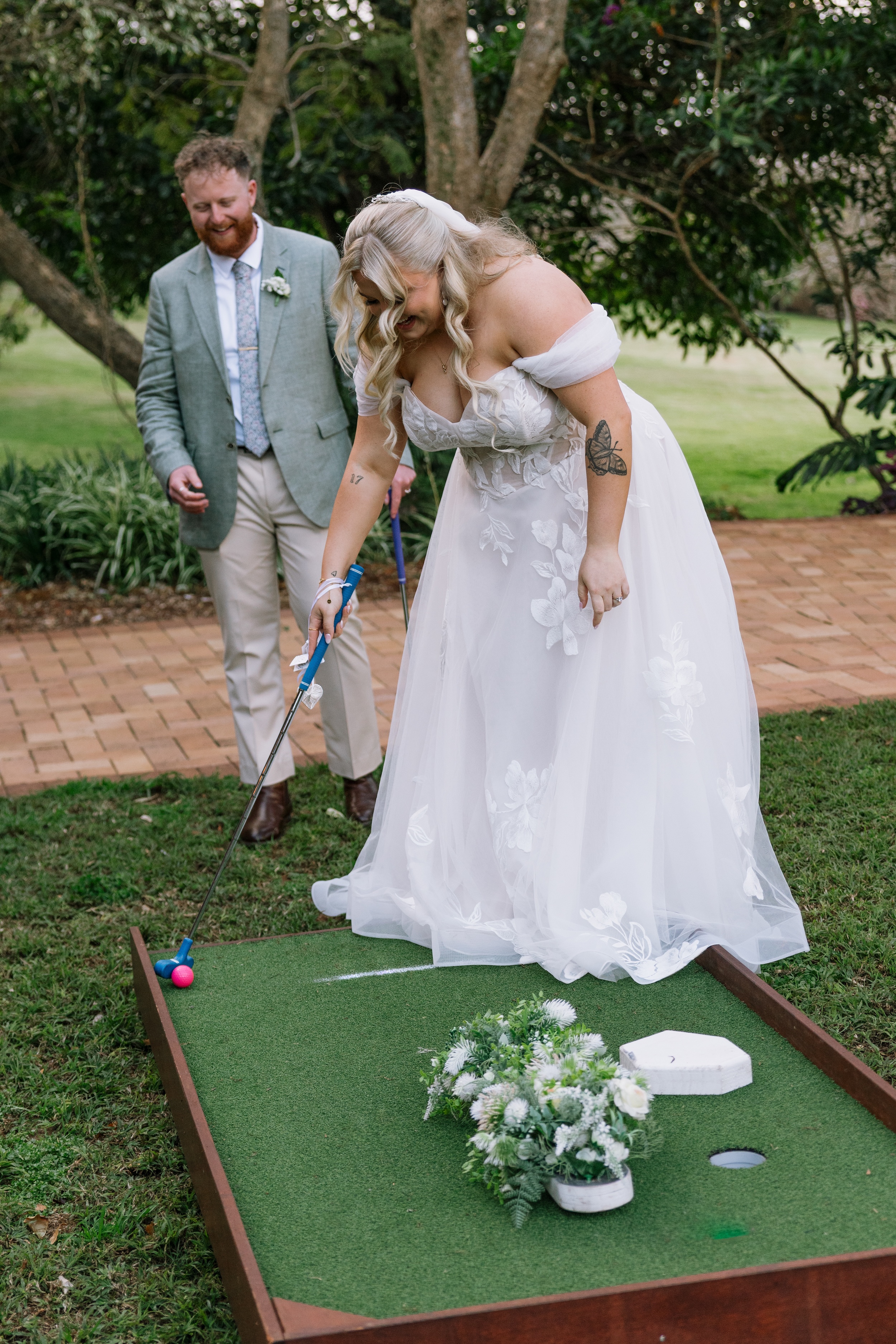 Bride putting on mini-golf course