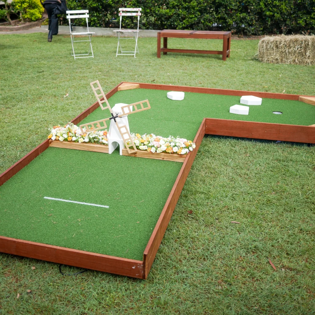 Detailed windmill obstacle on a Club Green mini-golf hole ready for guests