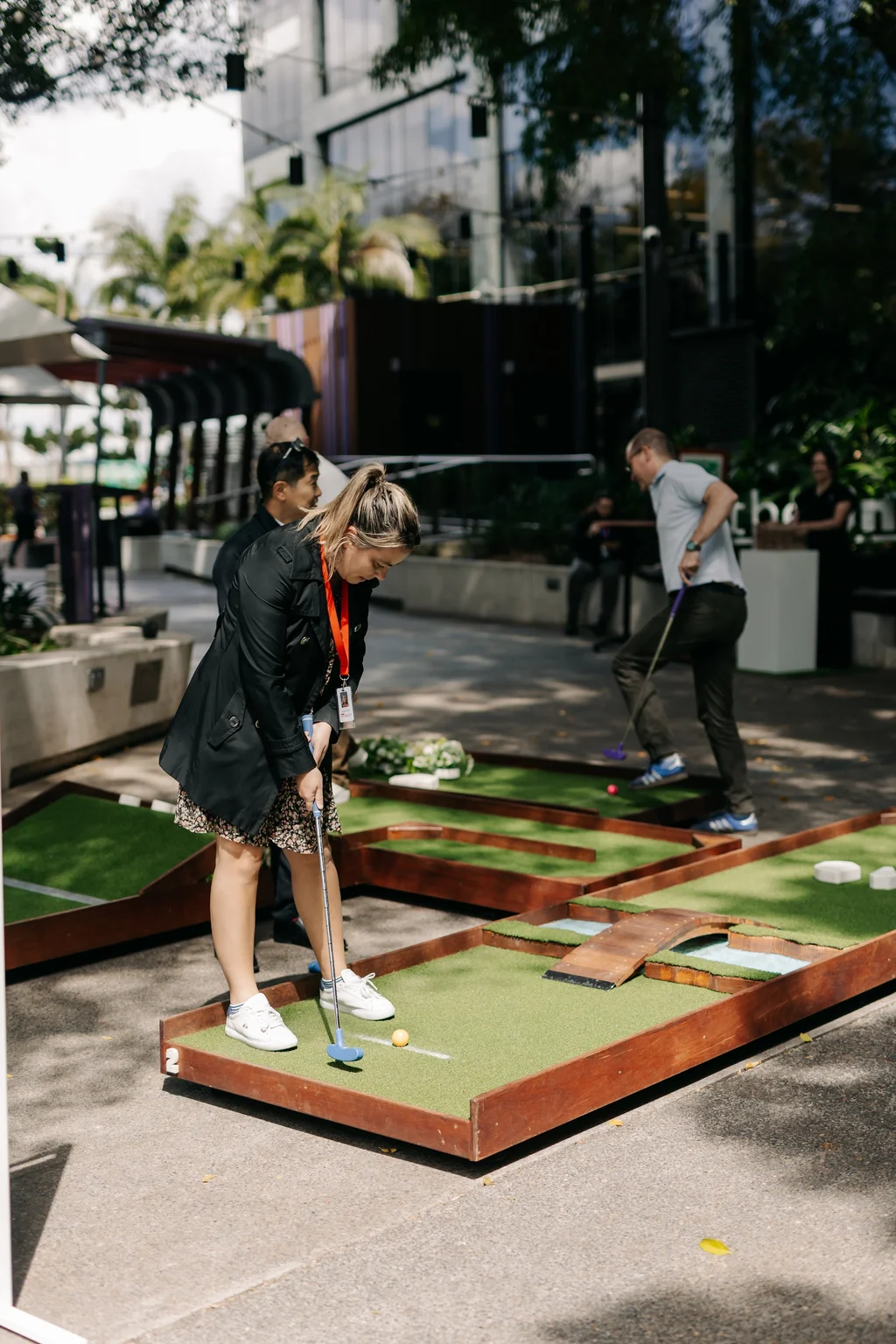 Wedding guest playing mini-golf